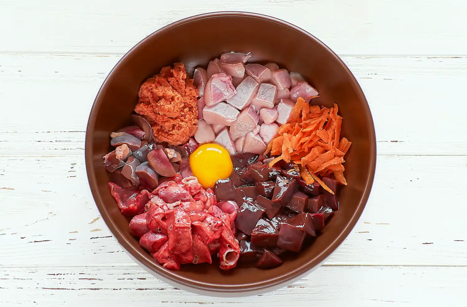 Photo de la composition d'une gamelle BARF pour un chien : des aliments naturels et crus